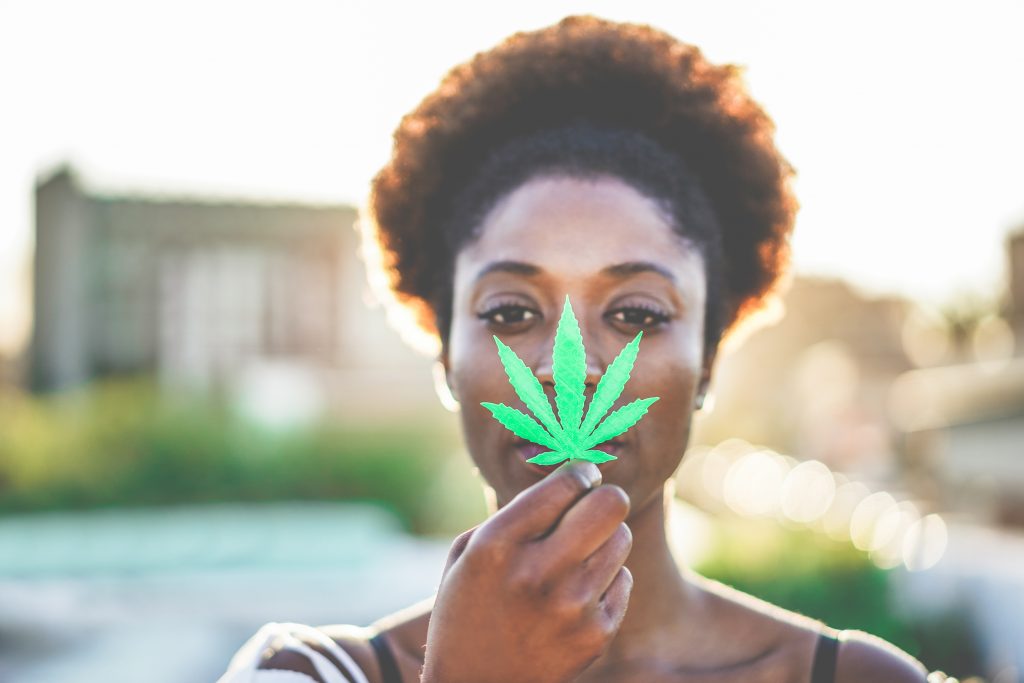 woman holding cannabis leaf for cannabis keto diet