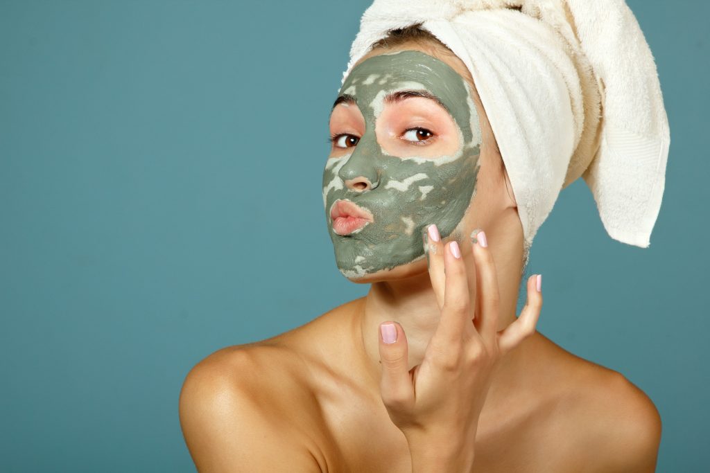 girl applying CBD infused face mask