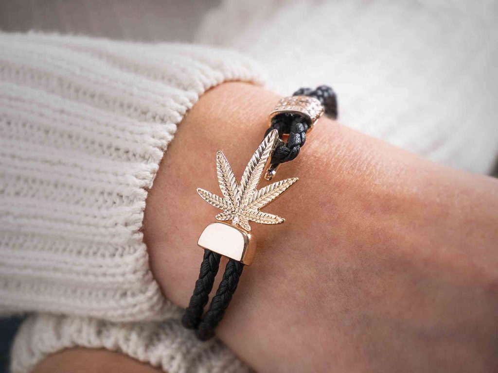 Model wears Black and rose gold marijuana bracelet