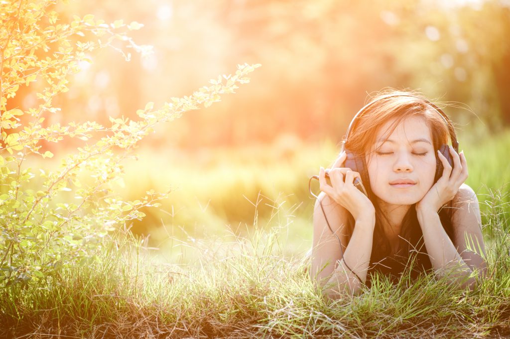 girl listening to relaxing music at a homemade cannabis retreat